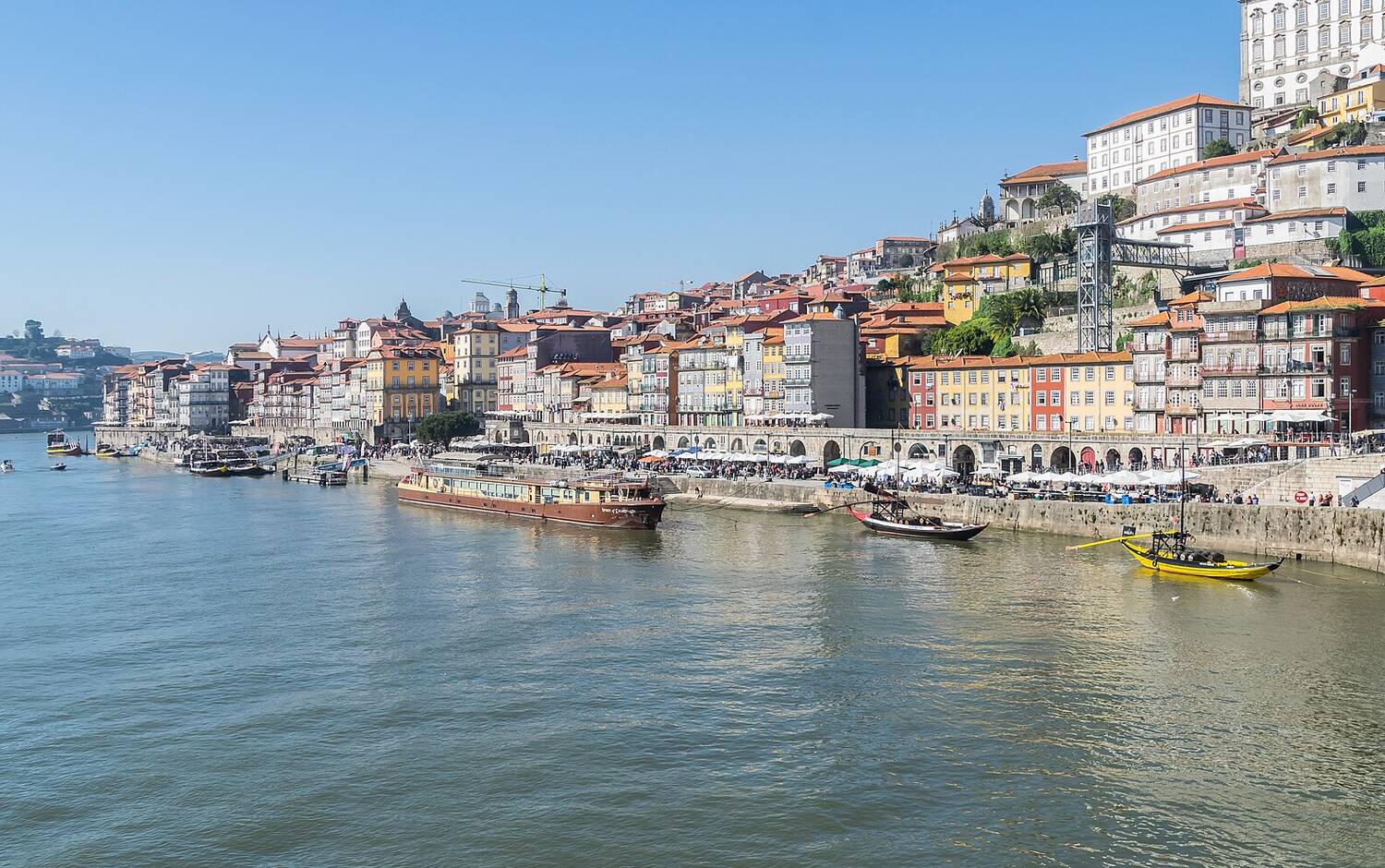 Terracotta rooftops and apartment buildings overlooking the Douro river in Porto, Portugal